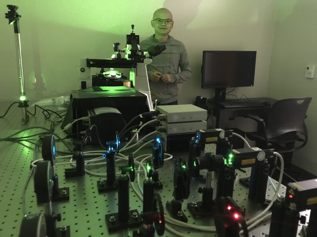 Dr. Hua Bao poses with his laser microscope set up.