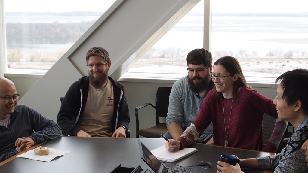 Lab members laughing around the conference table.