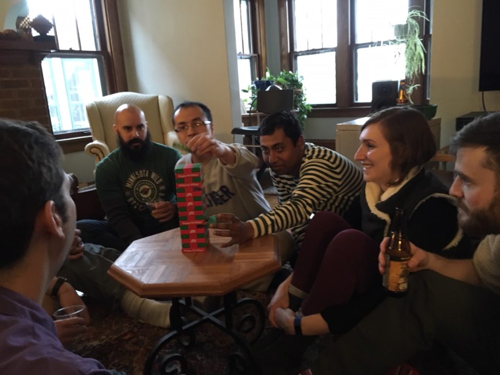 Lab members gathered around the Jenga tower.