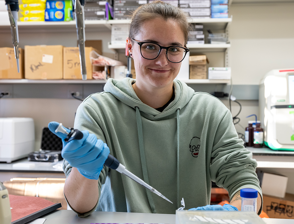 Research technician Miranda Pamperin pipettes at their bench.